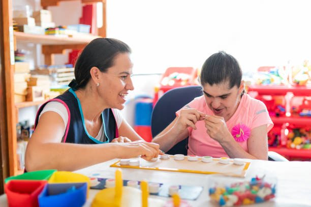 Mental Health Professional playing with Down Syndrome woman at School